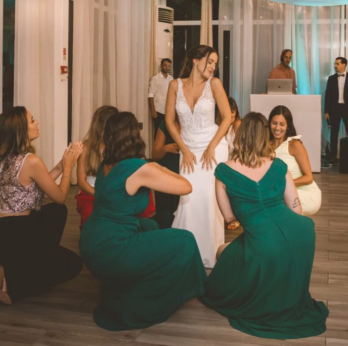 Damas de honor de joelhos a aplaudir a noiva a dançar
